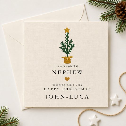 Personalised Christmas card for nephew featuring a hand-layered green Christmas tree with gold star and gold bow pot, personalised with the name John-Luca, sent with a white envelope