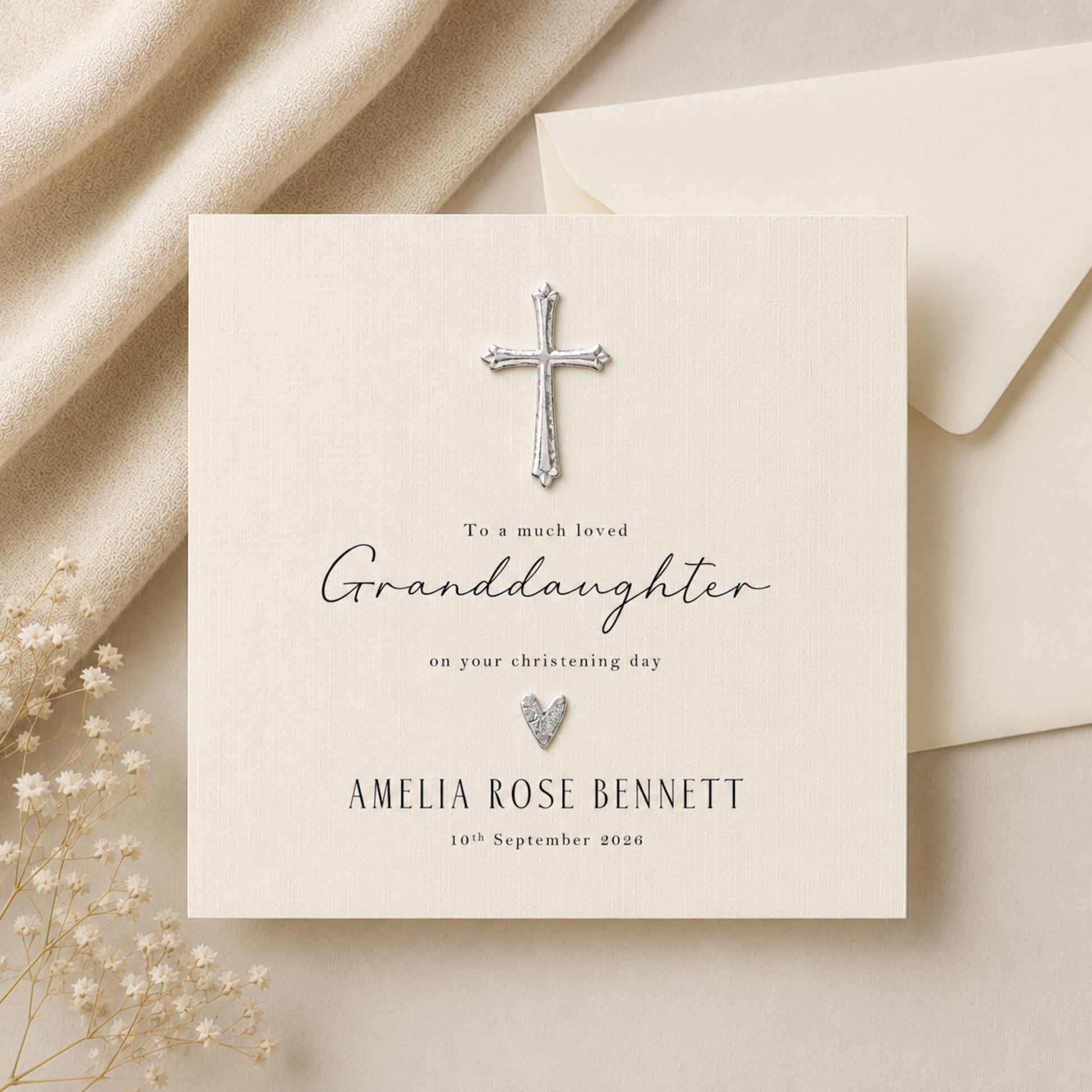 Personalised granddaughter christening card with silver cross and heart embellishment on ivory linen card