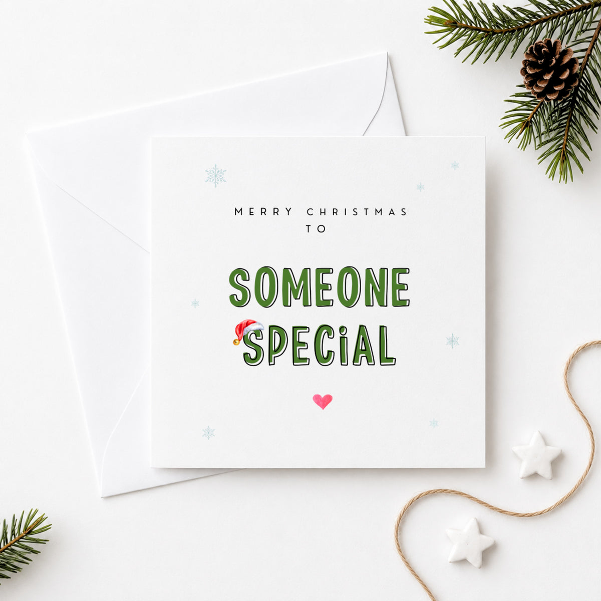 Merry Christmas to Someone Special card featuring bold green lettering with a Santa hat, snowflake details and a pink heart, sent with a white envelope